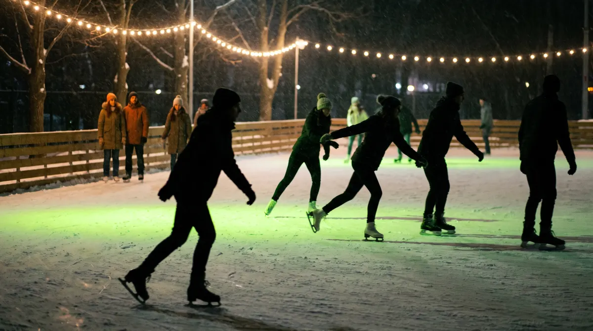 Skaters gliding across ice glowing lime green under night lights